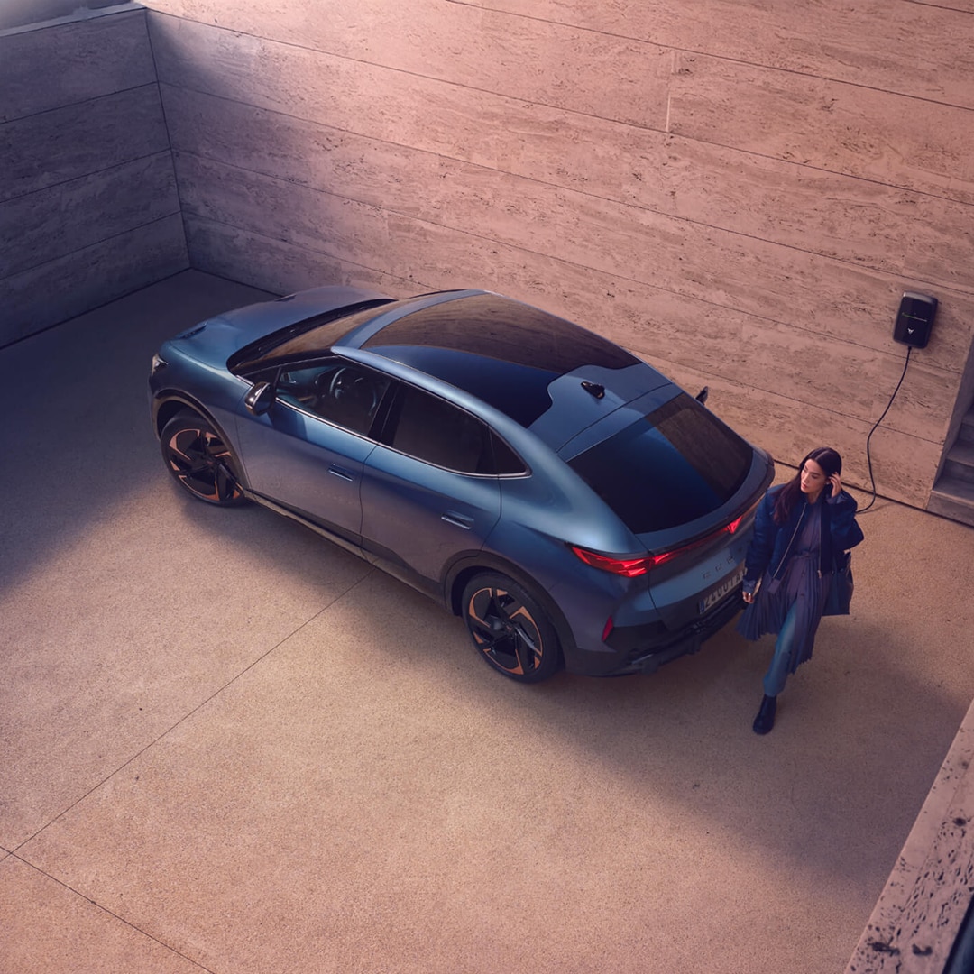 man using a smartphone in a city setting, representing general enquiries for cupra formentor. 