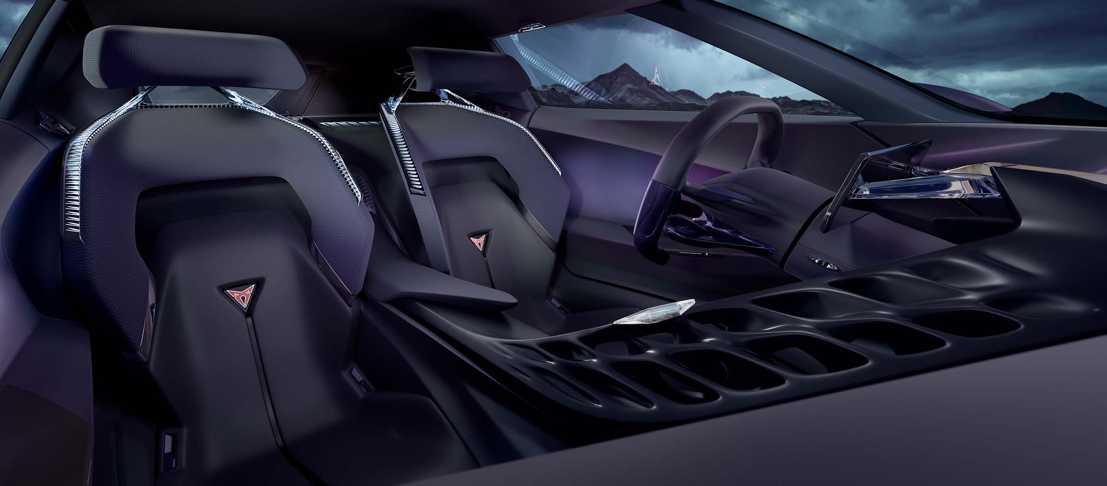 CUPRA DarkRebel car’s front bucket seats with CUPRA logos, central spine, gamified steering wheel and infotainment system.